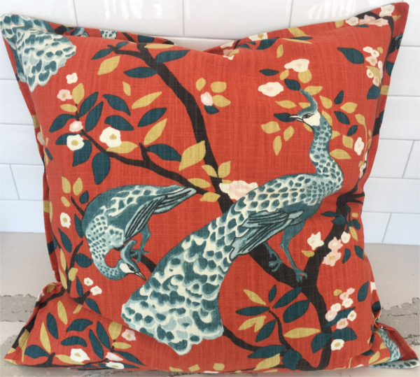 Custom pillow with peacocks on burnt orange background